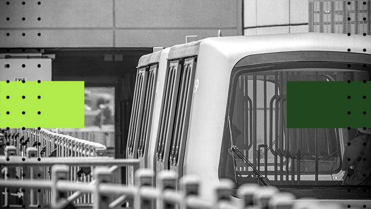 Rear view of a sky train stopped at a station 