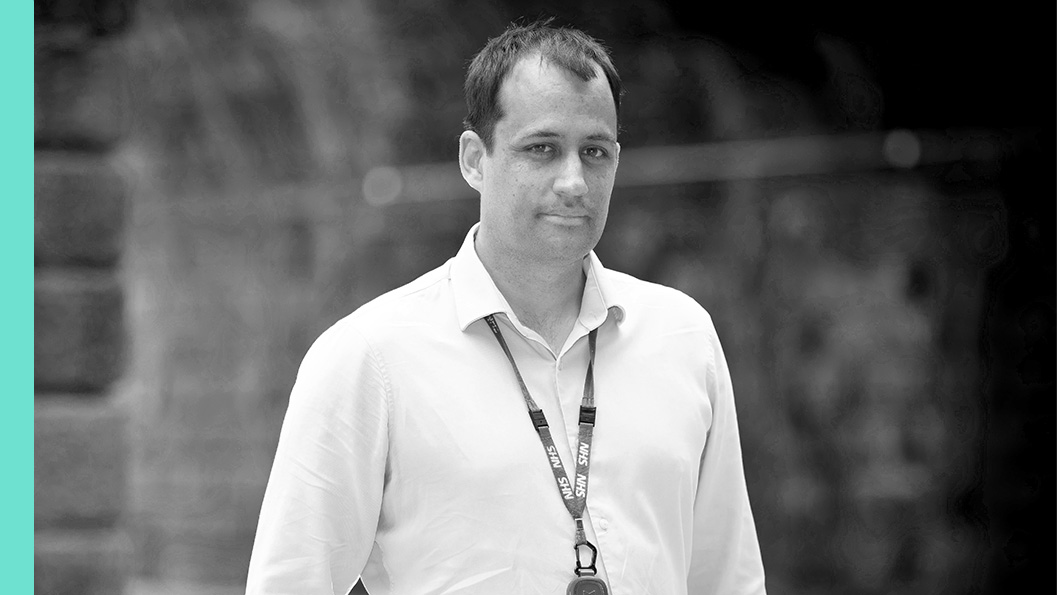 A man with a lanyard around his neck